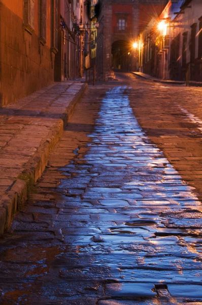 Mexico Lanterns reflect on cobblestone street